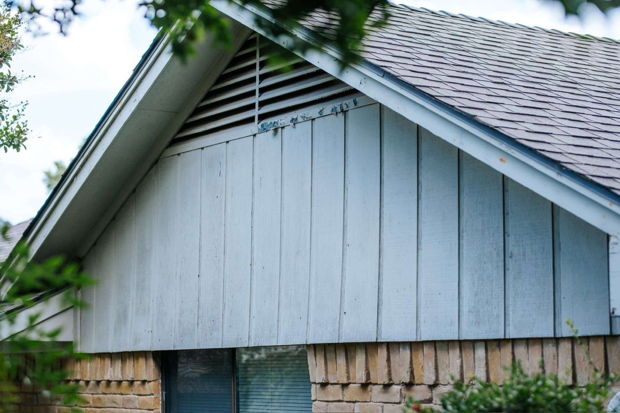 Before siding repair - damaged siding in Dallas